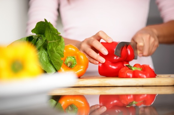 Peppers - woman cutting red pepper